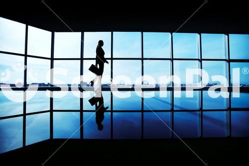 Outline Of Office Worker With Briefcase Walking Along Window